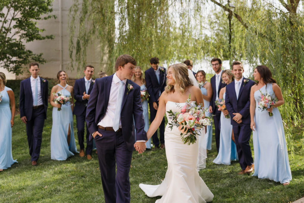 A bride and groom with their bridal party in front of the Willow tree at WinMock.