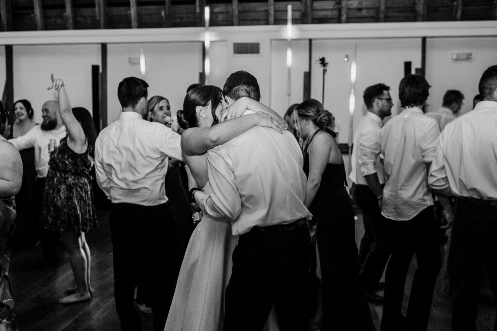 A candid photo of a bride and groom on the dance floor. 